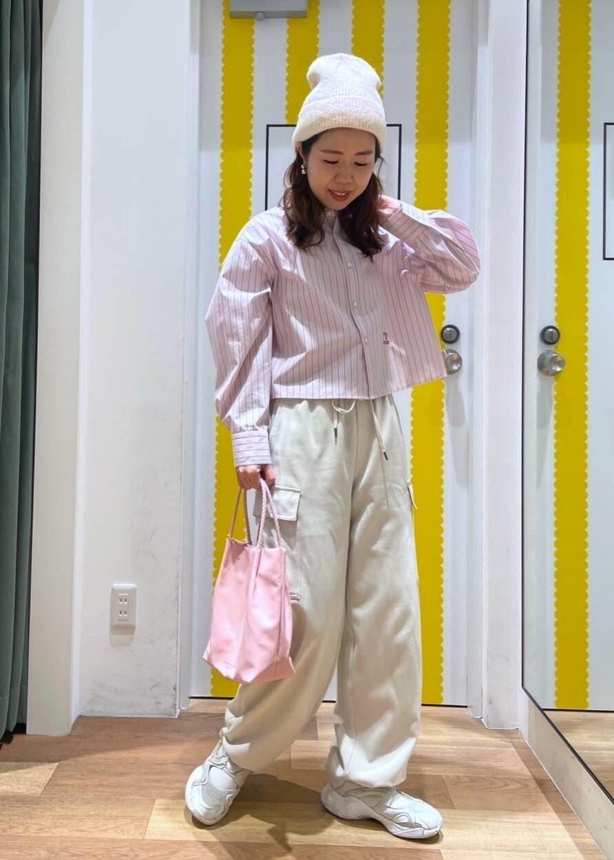 ベージュ系のカーゴパンツ、ピンク系のトートバッグ、ピンク系のシャツ/ブラウスを着用したレディースの冬コーディネートの2枚目の写真