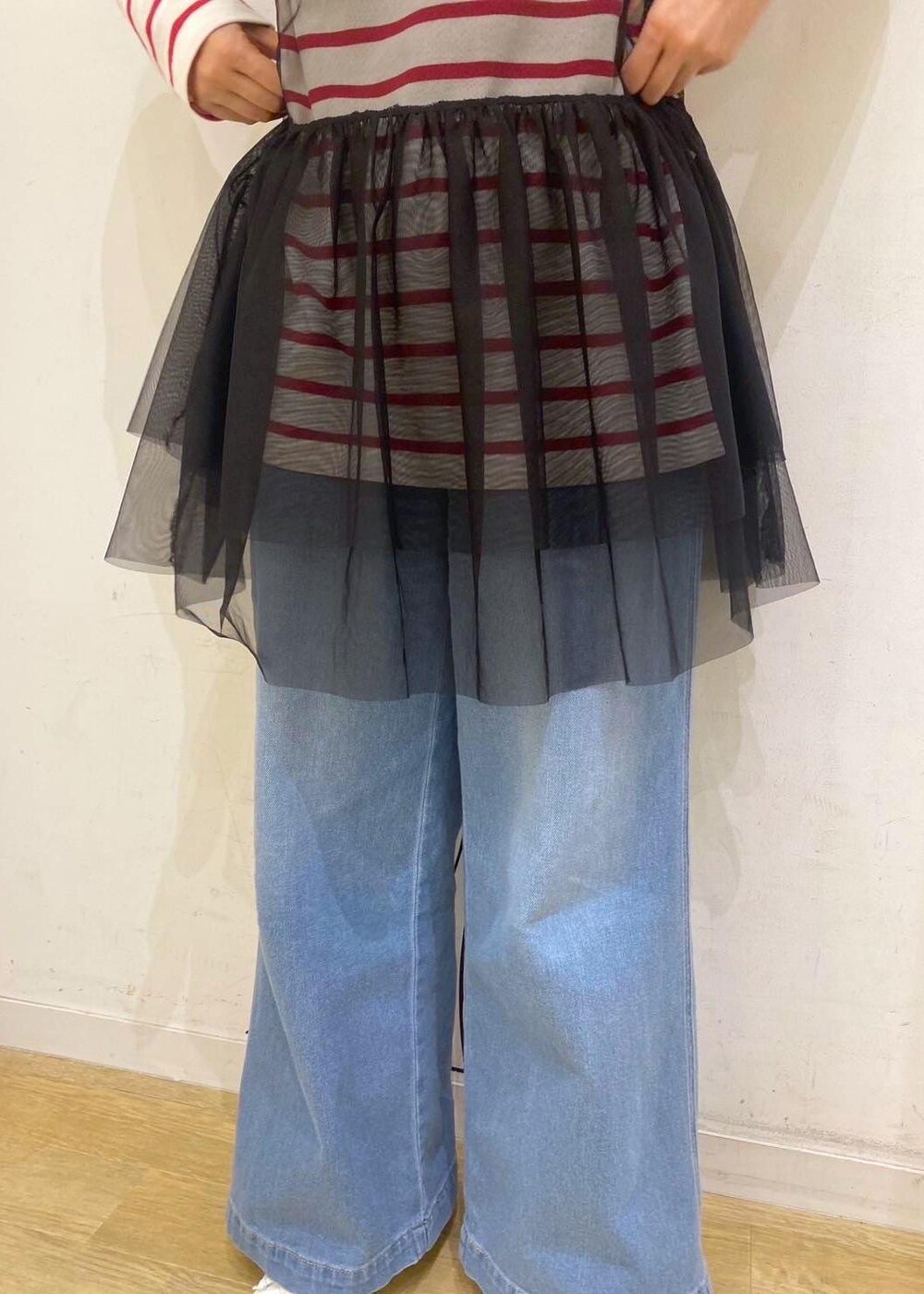 ブラック系のベスト、レッド系のTシャツ/カットソー、ホワイト系のパンプスを着用したレディースの春コーディネートの5枚目の写真