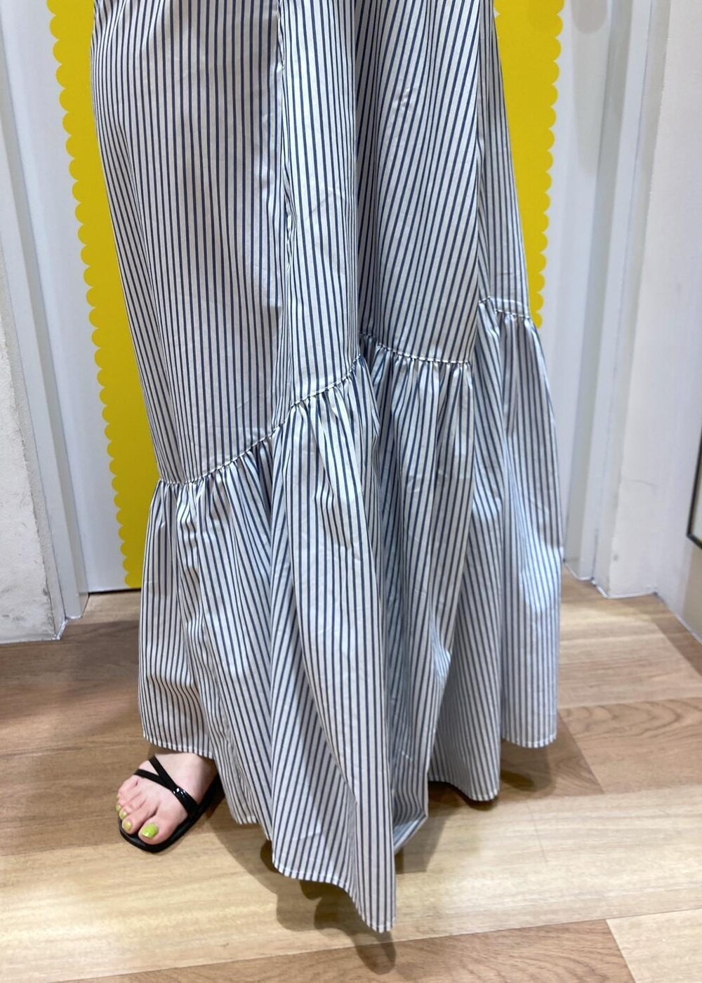 ブラック系のサンダル、ホワイト系のショルダーバッグ、ブルー系のシャツワンピースを着用したレディースの春コーディネートの5枚目の写真