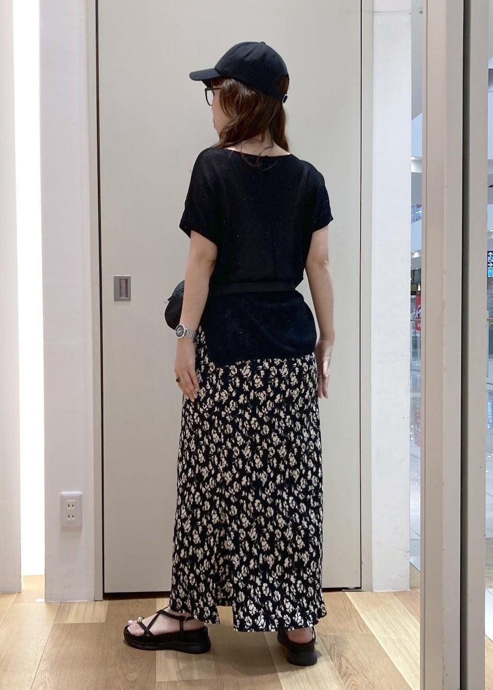 ブラック系のスカート、ブラック系のサンダル、ブラック系のニット/セーターを着用したレディースの夏コーディネートの3枚目の写真