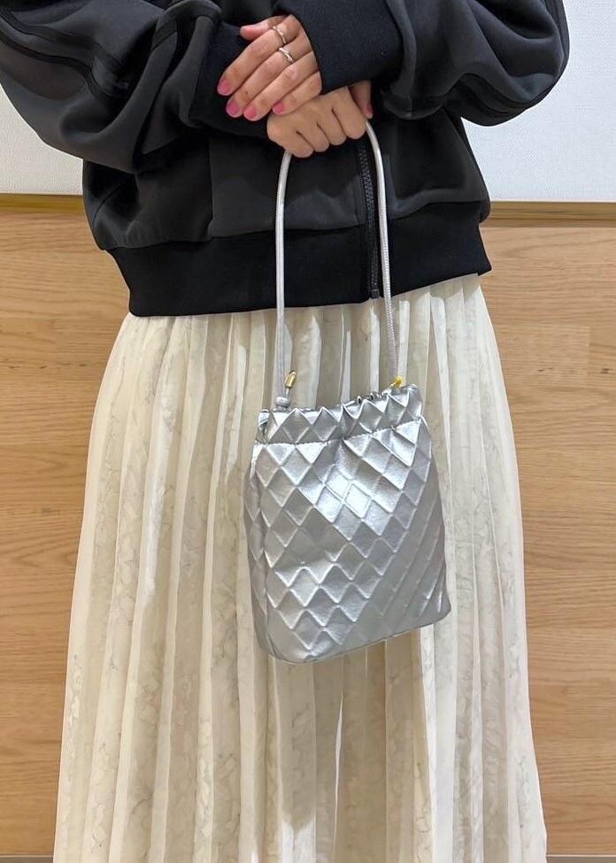 シルバー系のショルダーバッグ、グレー系のその他アウター、ホワイト系のスカートを着用したレディースの冬コーディネートの4枚目の写真