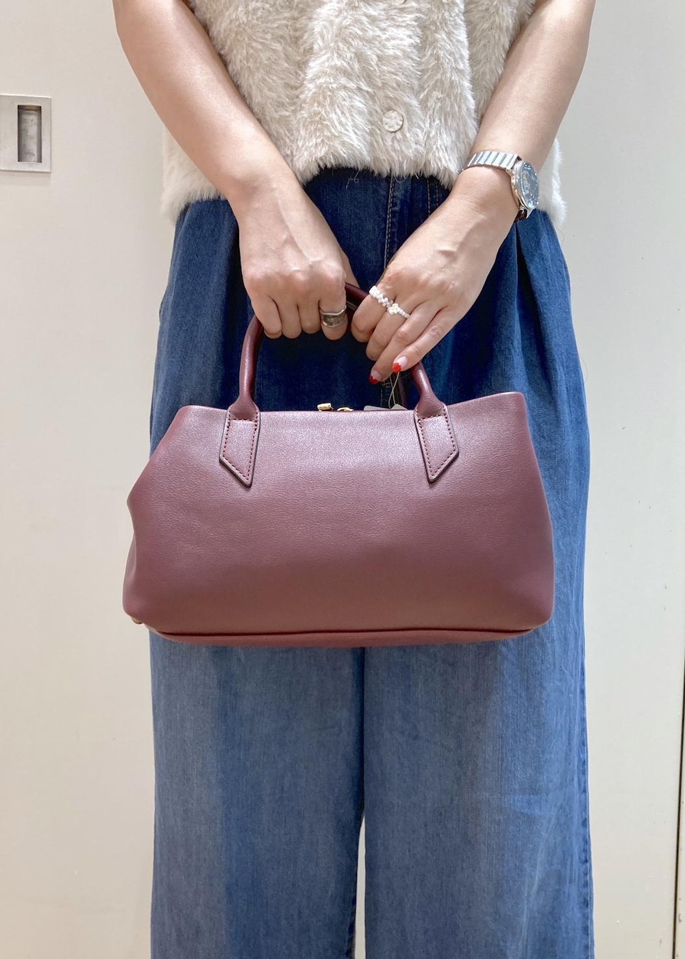 ブラウン系のパンプス、ブルー系のデニムパンツ、レッド系のトートバッグを着用したレディースの夏コーディネートの7枚目の写真