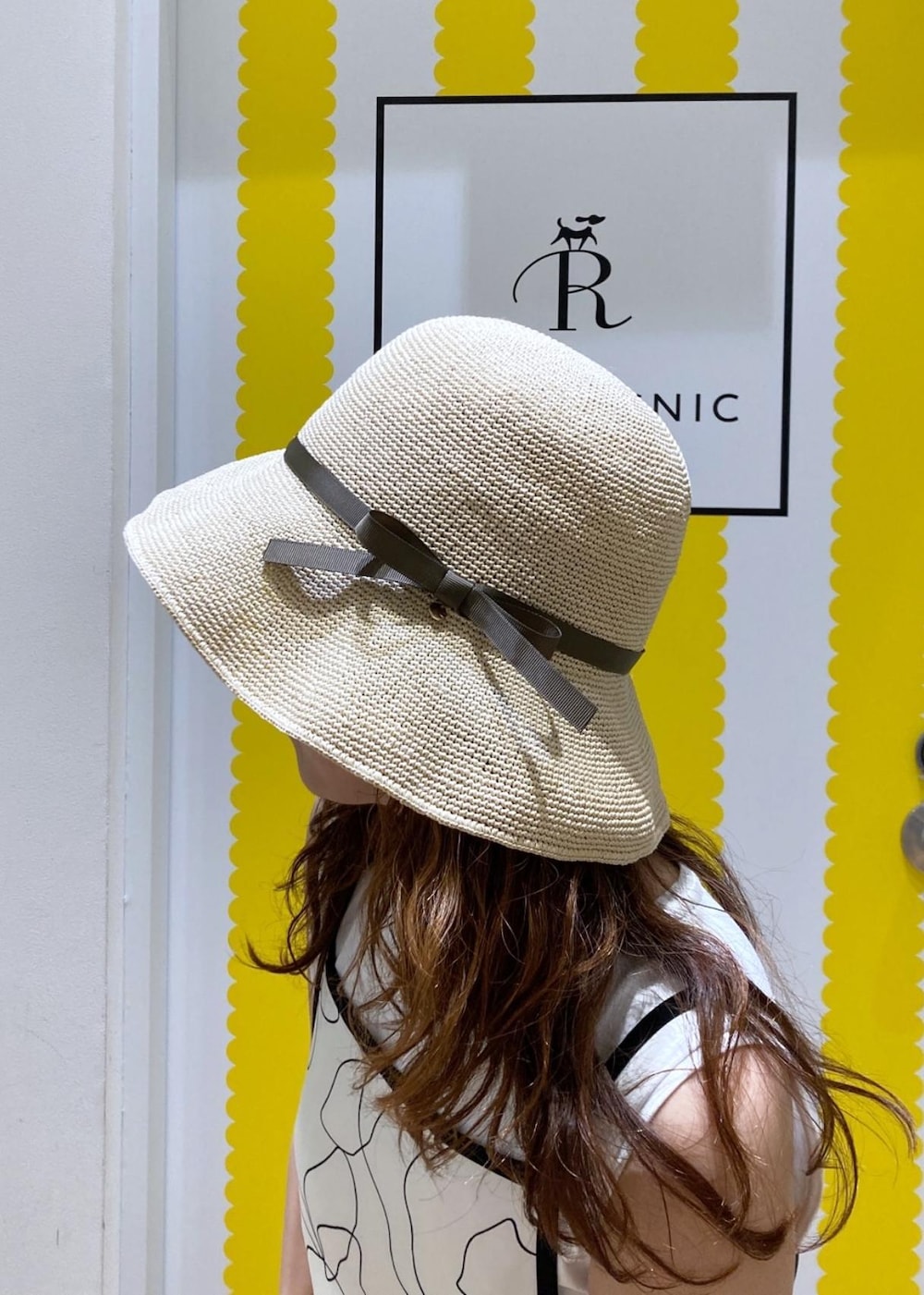 ホワイト系のワンピース、ベージュ系のTシャツ/カットソー、ブラック系のサンダルを着用したレディースの春コーディネートの4枚目の写真