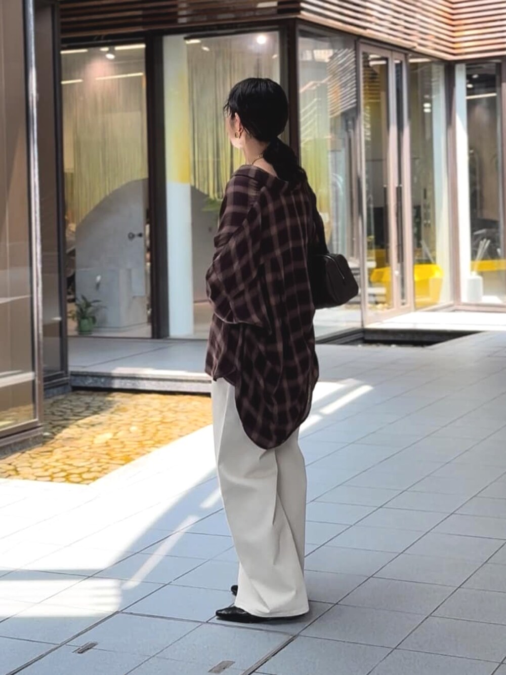 ベージュ系のシャツ/ブラウス、ブラック系のその他シューズ、ホワイト系のデニムパンツを着用したレディースの夏コーディネートの3枚目の写真