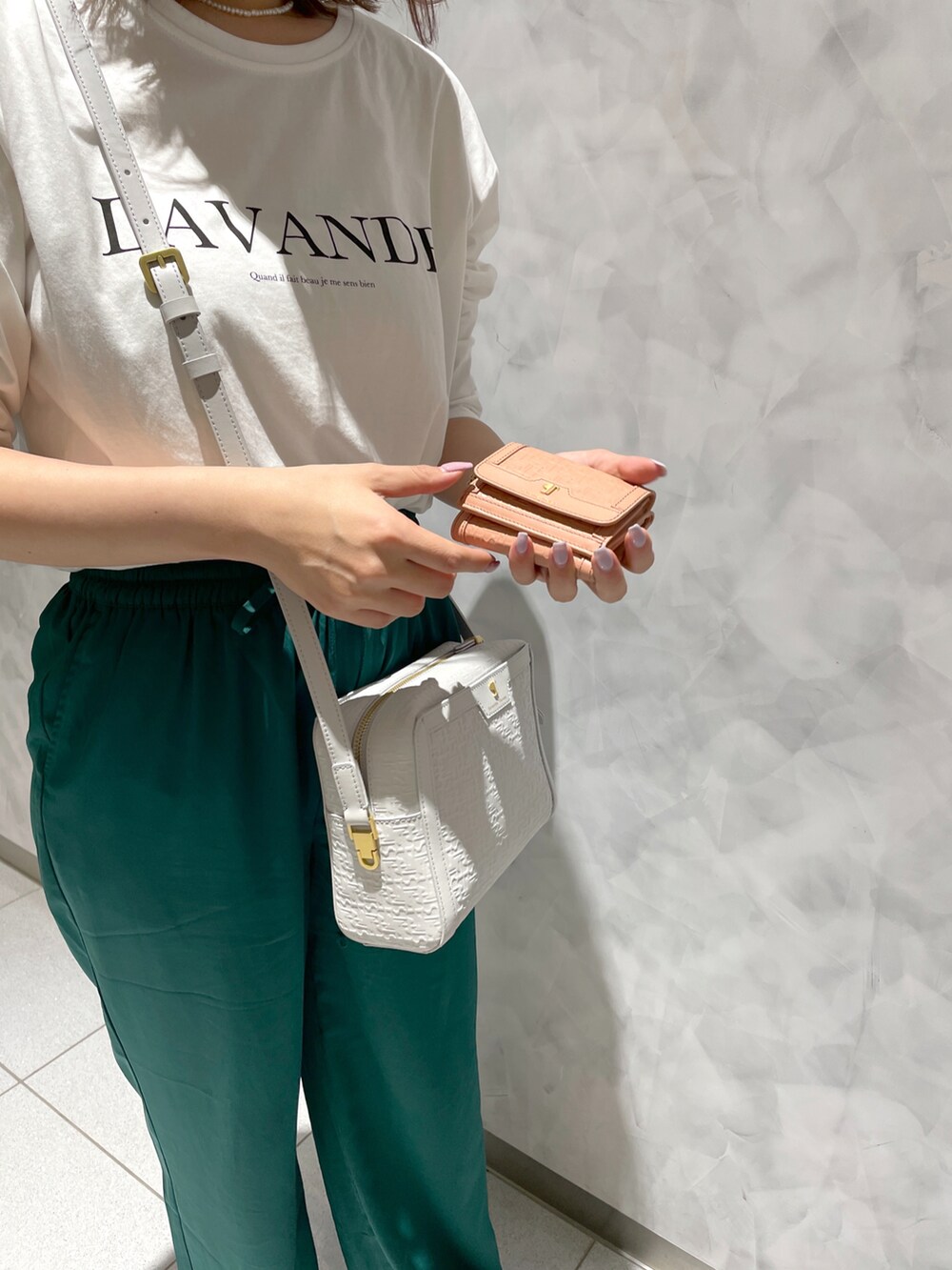 グリーン系のその他パンツ、グレー系のショルダーバッグ、ピンク系の財布を着用したレディースの春コーディネートの3枚目の写真