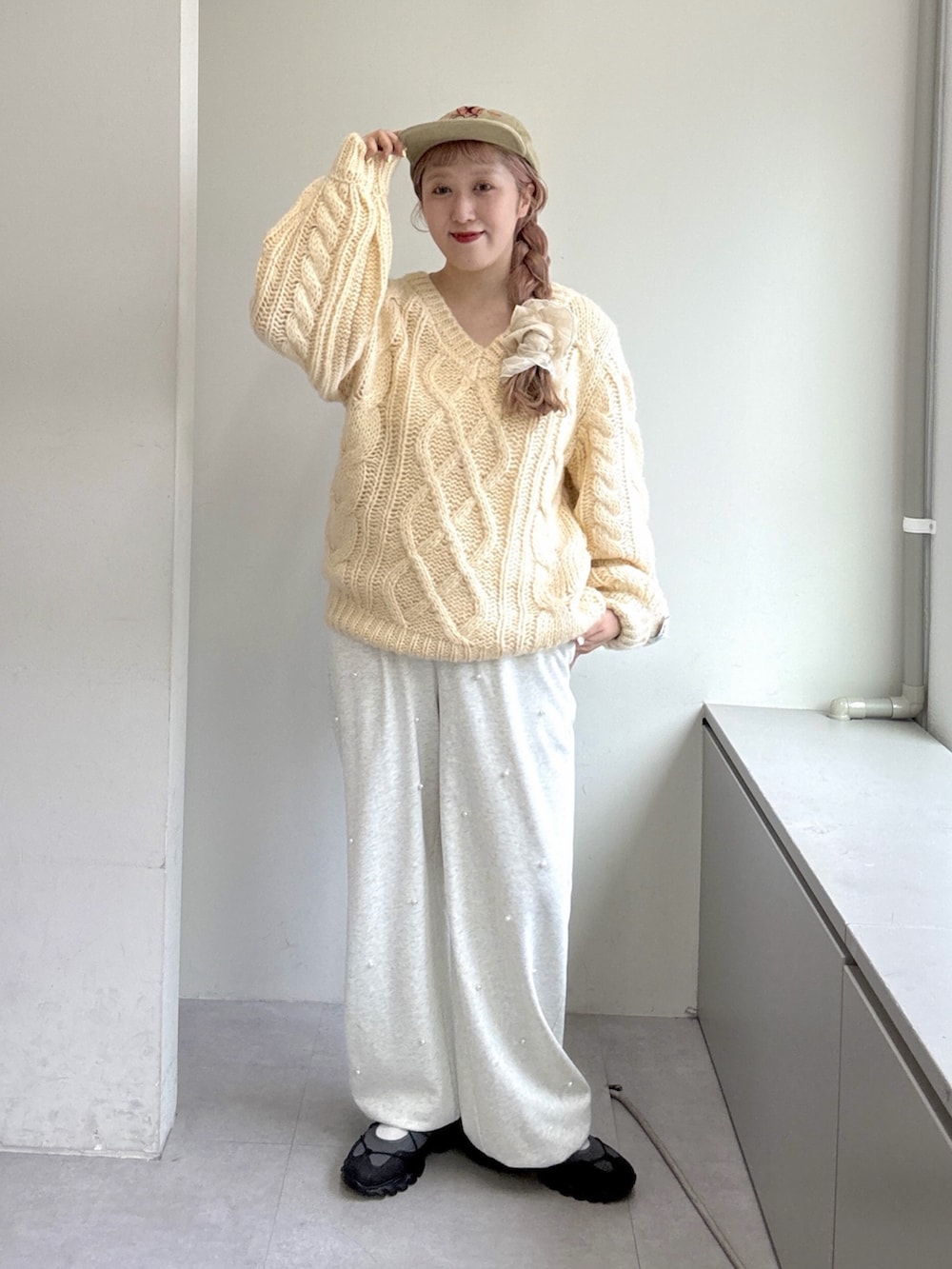 ホワイト系のニット/セーター、ホワイト系のその他パンツ、グレー系のスニーカーを着用したレディースの夏コーディネートの2枚目の写真