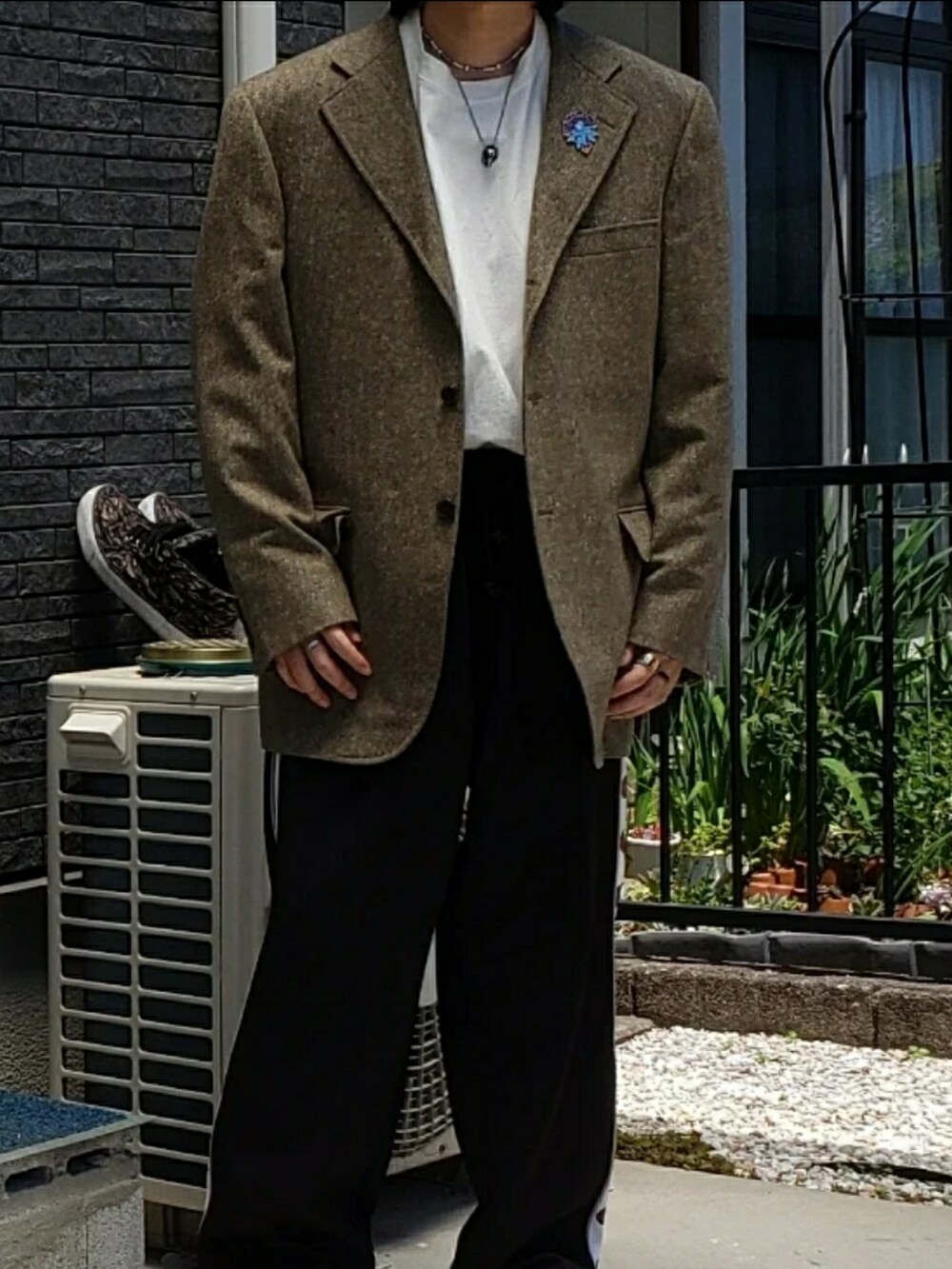 ホワイト系のスリッポン、ブラック系のパンツ、ホワイト系のTシャツ/カットソーを着用したメンズの冬コーディネートの3枚目の写真