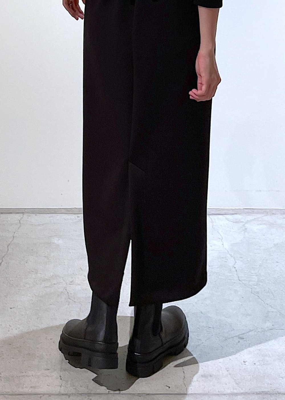 ブルー系のピーコート、ブラック系のブーツ、ブラック系のスカートを着用したレディースの秋コーディネートの9枚目の写真