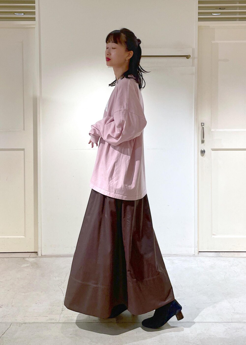 ブラウン系のスカート、ピンク系のTシャツ/カットソーを着用したレディースの秋コーディネートの2枚目の写真