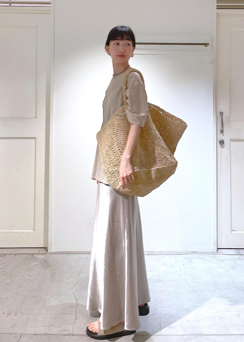 ベージュ系のサンダル、ベージュ系のスカート、ベージュ系のTシャツ/カットソーを着用したレディースの春コーディネートの4枚目の写真