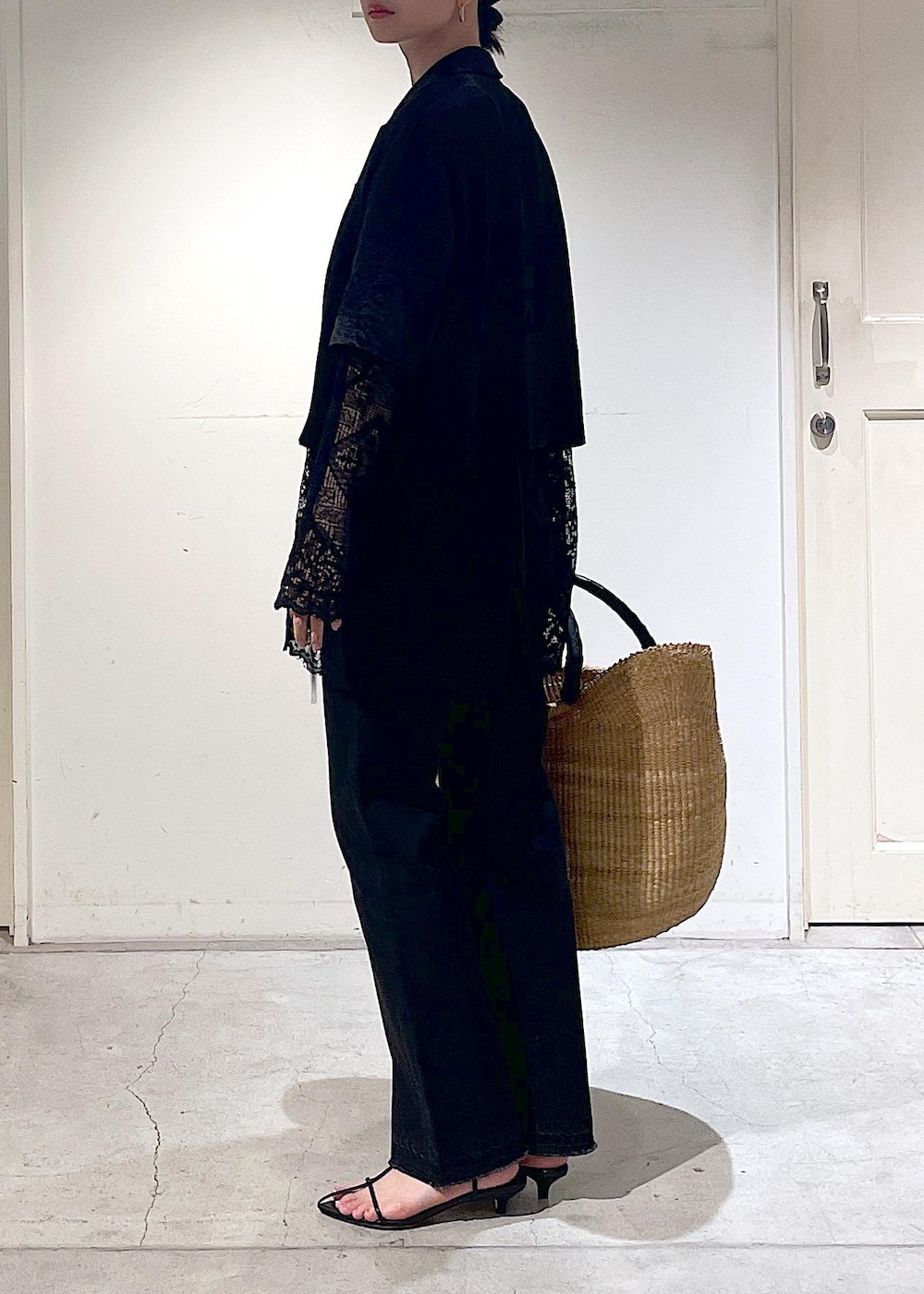 グレー系のデニムパンツ、ブラック系のノーカラージャケット、ブラック系のサンダルを着用したレディースの夏コーディネートの3枚目の写真