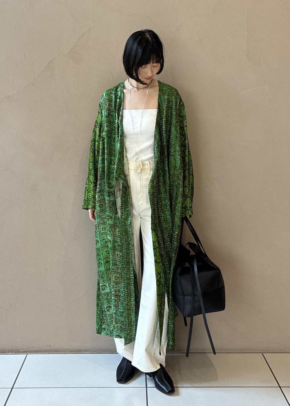 ブラック系のその他シューズ、ブラック系のハンドバッグを着用したレディースの冬コーディネートの2枚目の写真