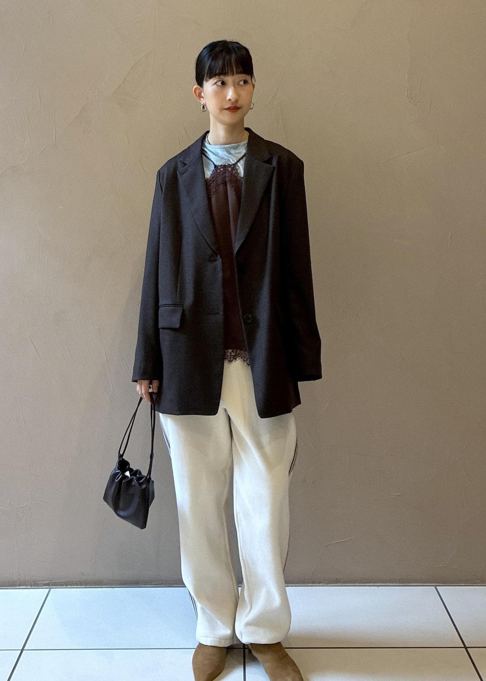 ホワイト系のその他パンツ、ブラウン系のキャミソール、ブラウン系のハンドバッグを着用したレディースの秋コーディネートの2枚目の写真