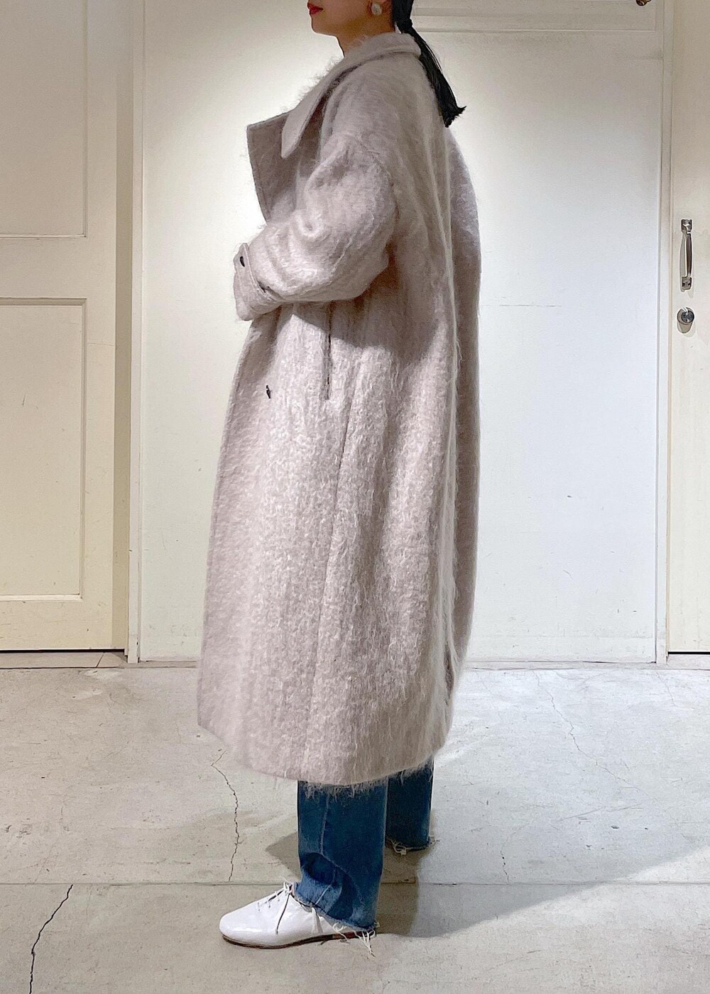 グレー系のその他アウター、ブルー系のデニムパンツ、ホワイト系のその他シューズを着用したレディースの冬コーディネートの8枚目の写真