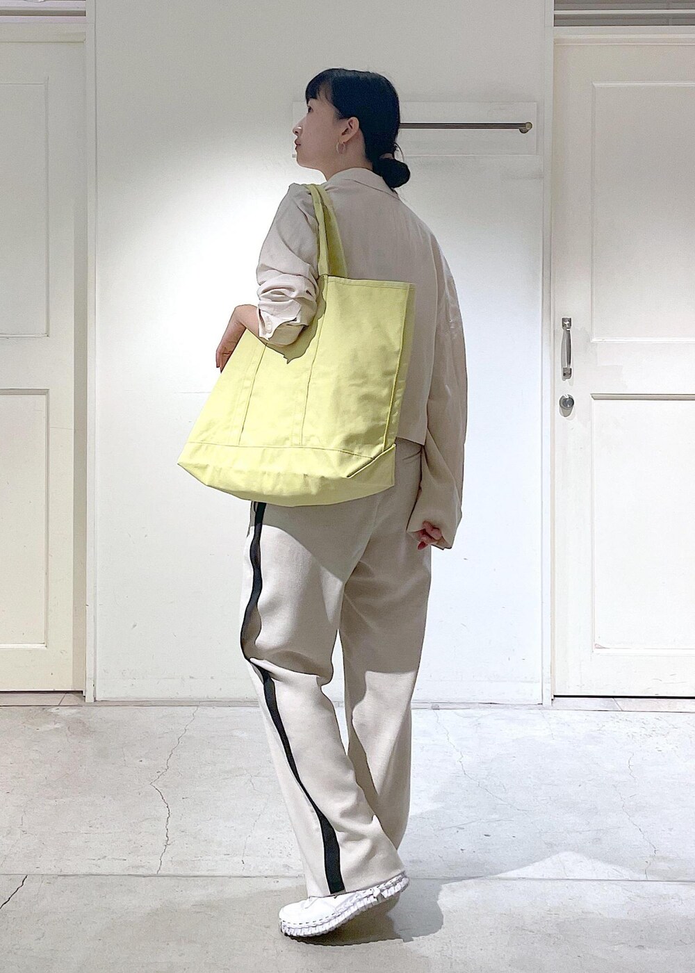 ホワイト系のキャミソール、ホワイト系のテーラードジャケットを着用したレディースの春コーディネートの3枚目の写真