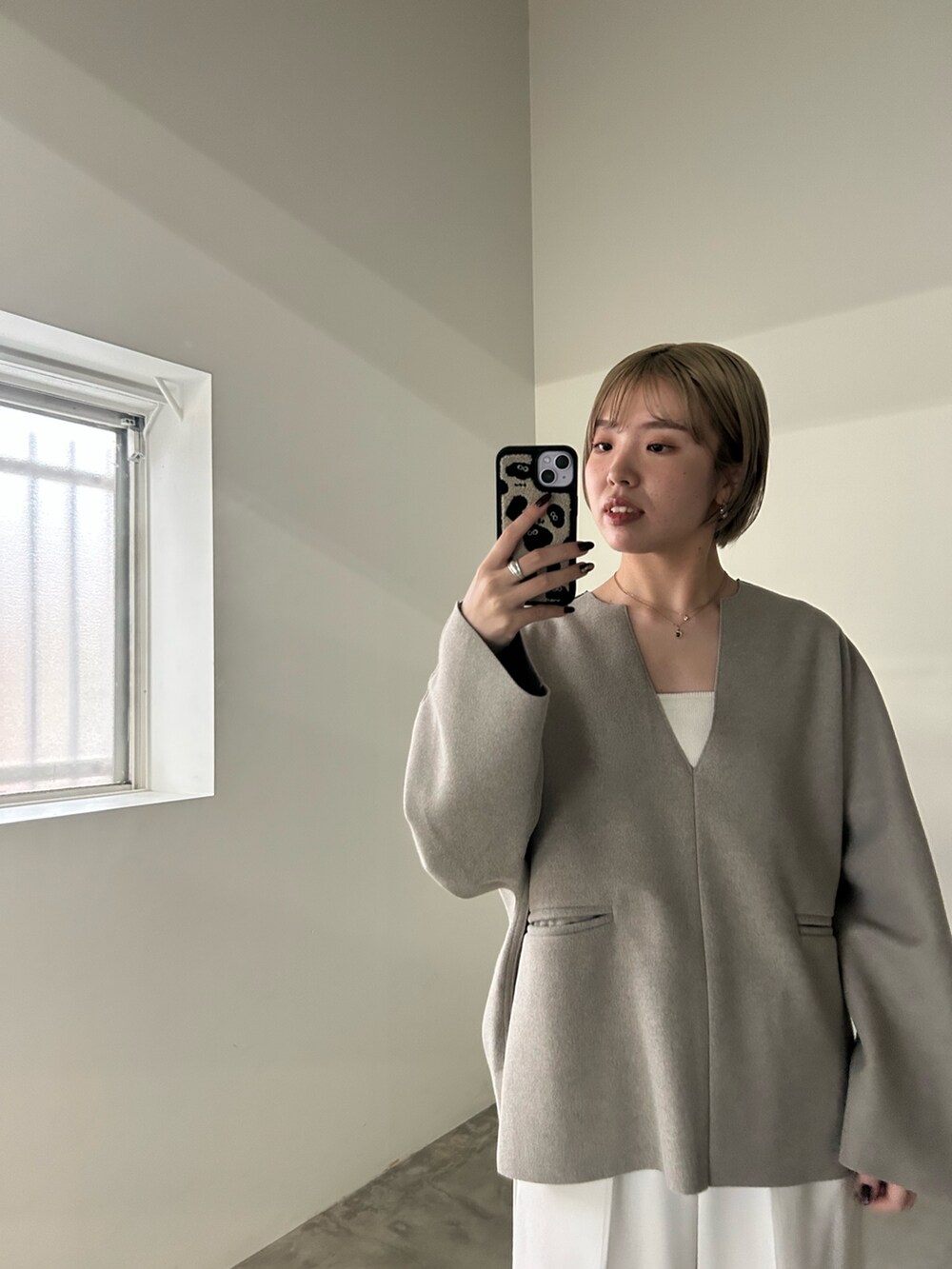 ホワイト系のスラックス、ホワイト系のキャミソール、ベージュ系のTシャツ/カットソーを着用したレディースの秋コーディネートの5枚目の写真