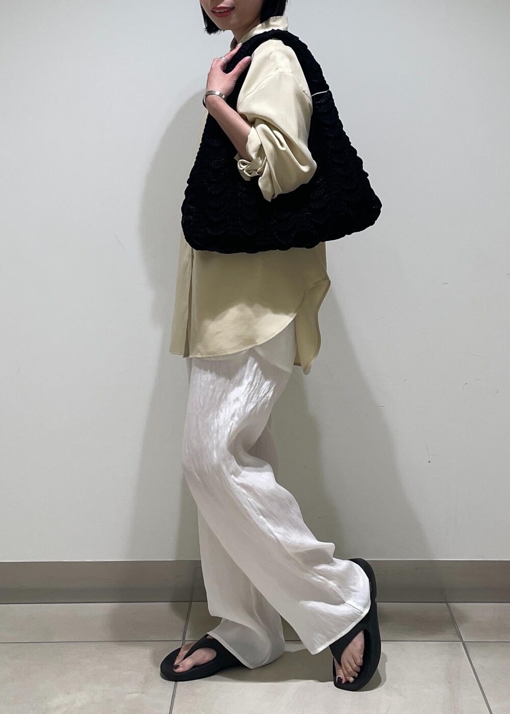 ホワイト系のその他パンツ、ブラック系のハンドバッグ、ベージュ系のシャツ/ブラウスを着用したレディースの夏コーディネートの5枚目の写真