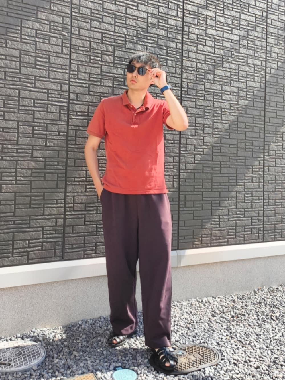 ブラック系のサンダル、その他のスウェットパンツ、レッド系のポロシャツを着用したメンズの夏コーディネートの2枚目の写真