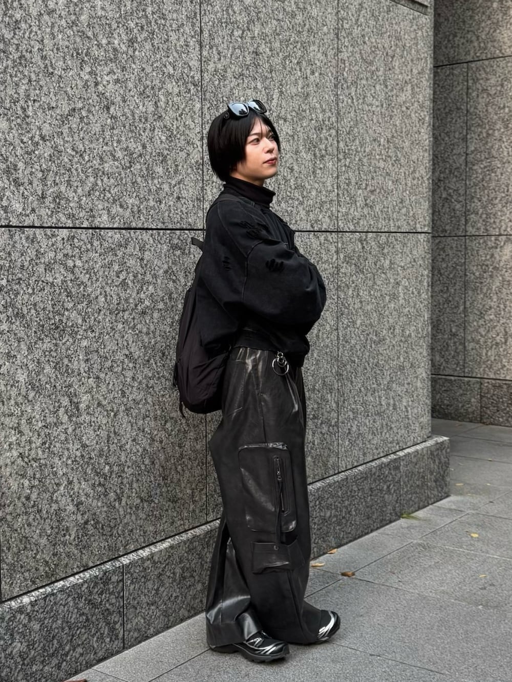 ブラック系のスウェット、ブラック系のカーゴパンツ、ブラック系のスニーカーを着用したメンズの秋コーディネートの2枚目の写真