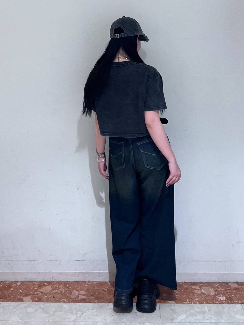 ブラック系のスニーカー、ブルー系のデニムパンツ、ブラック系のTシャツ/カットソーを着用したレディースの春コーディネートの8枚目の写真