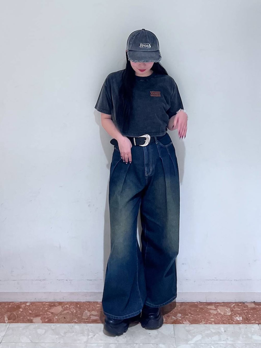 ブラック系のスニーカー、ブルー系のデニムパンツ、ブラック系のTシャツ/カットソーを着用したレディースの春コーディネートの3枚目の写真