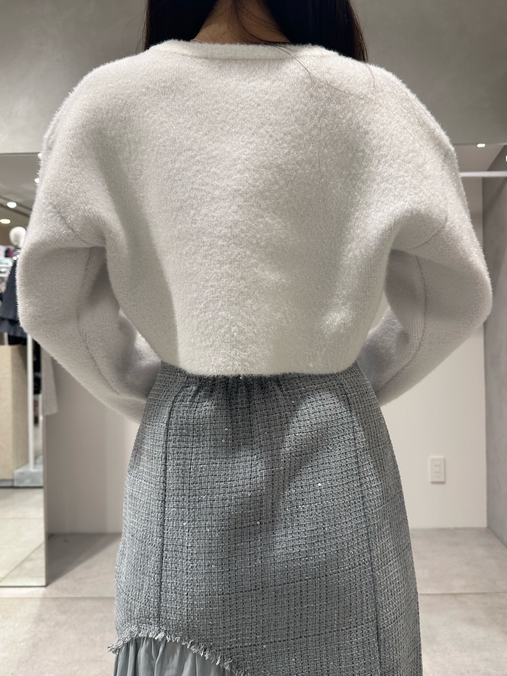 ホワイト系のカーディガン/ボレロ、ブラウン系のハンドバッグ、グリーン系のスカートを着用したレディースの秋コーディネートの6枚目の写真