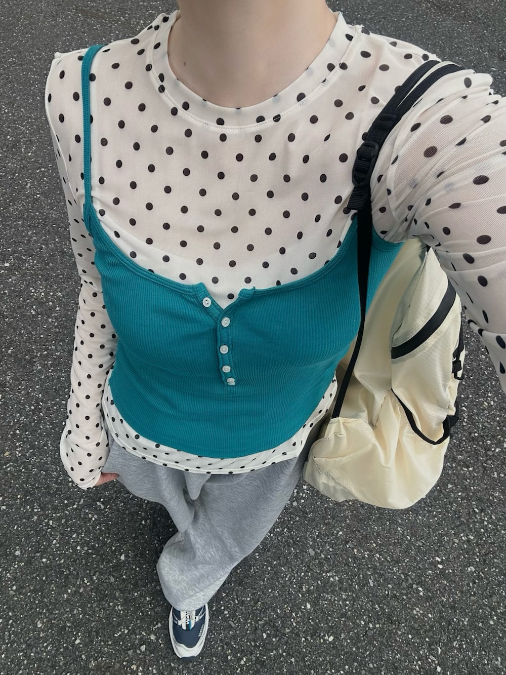 グレー系のスウェットパンツ、イエロー系のバックパック/リュック、ブルー系のスニーカーを着用したレディースの夏コーディネートの2枚目の写真