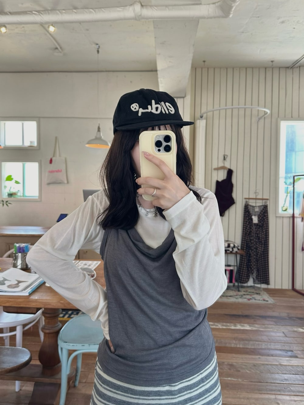ホワイト系のTシャツ/カットソー、グレー系のスカート、ブルー系のショルダーバッグを着用したレディースの春コーディネートの2枚目の写真