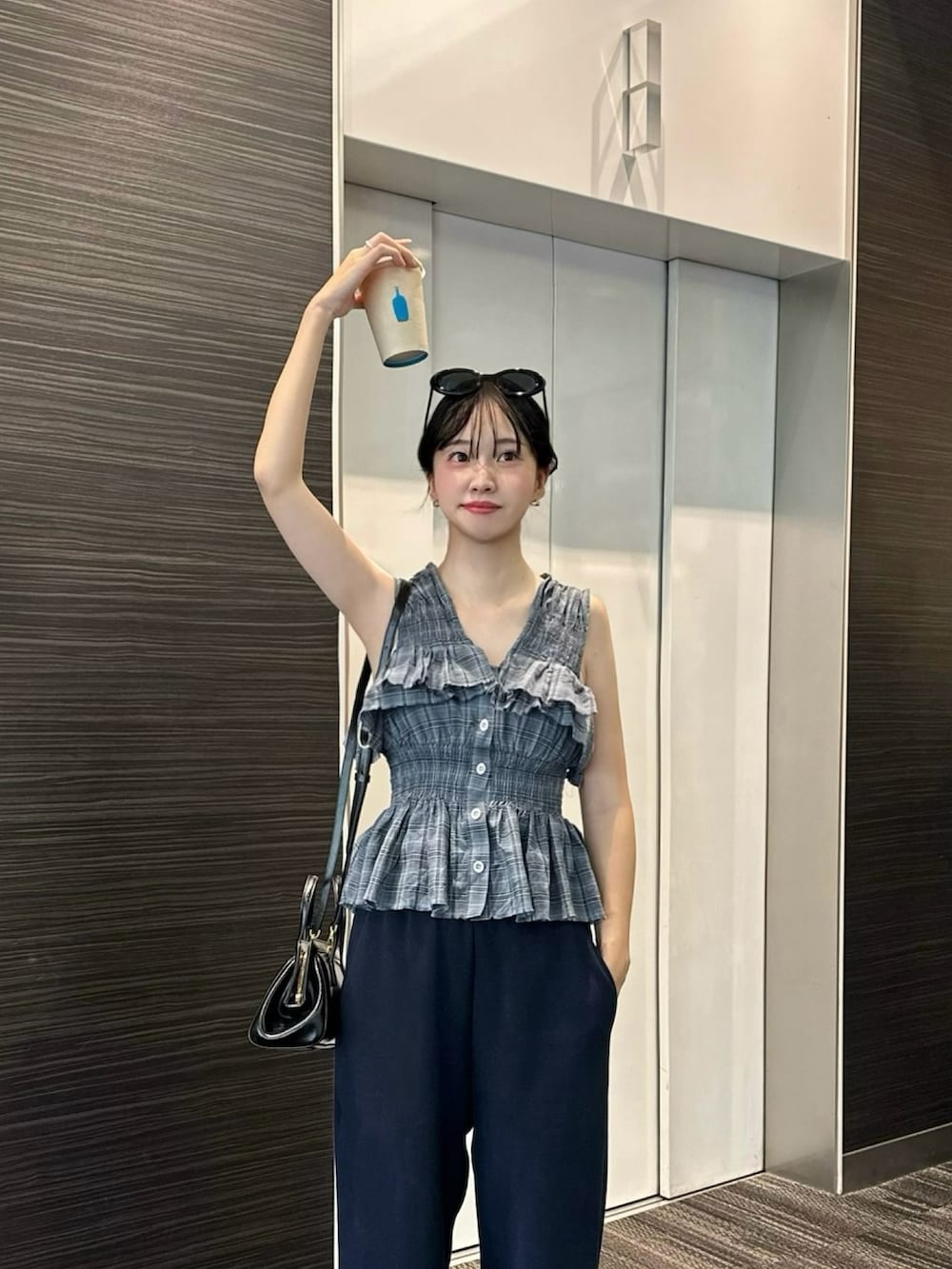 ブルー系のシャツ/ブラウス、ブルー系のスウェットパンツ、グレー系のスニーカーを着用したレディースの夏コーディネートの2枚目の写真