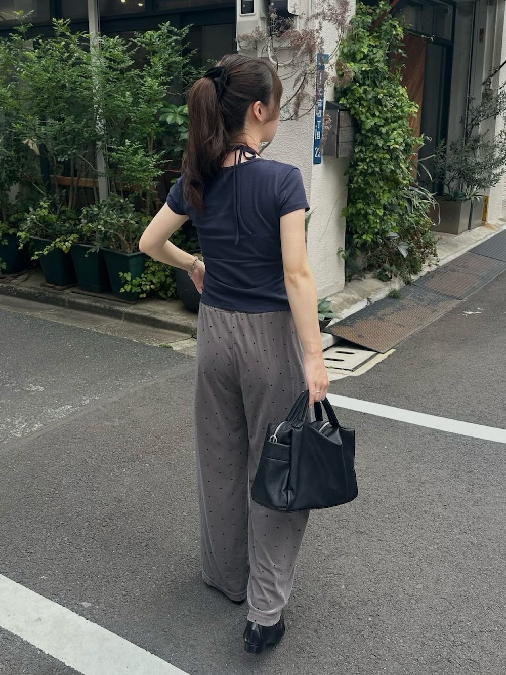 ブラック系のボストンバッグ、グレー系のその他パンツ、ブラック系のローファーを着用したレディースの夏コーディネートの2枚目の写真