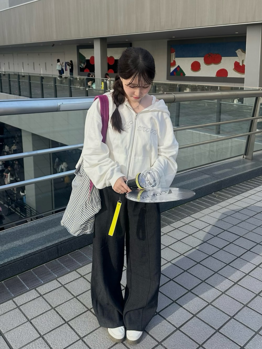 ホワイト系のスニーカー、ホワイト系のパーカー、グレー系のパンツを着用したレディースの秋コーディネートの2枚目の写真
