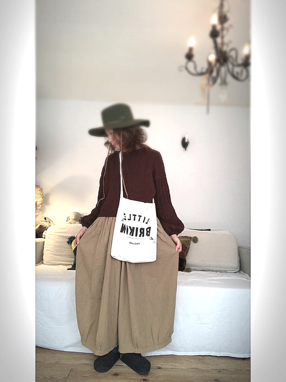 ブラウン系のニット/セーター、ホワイト系のショルダーバッグ、ベージュ系のパンツを着用したレディースの冬コーディネートの2枚目の写真