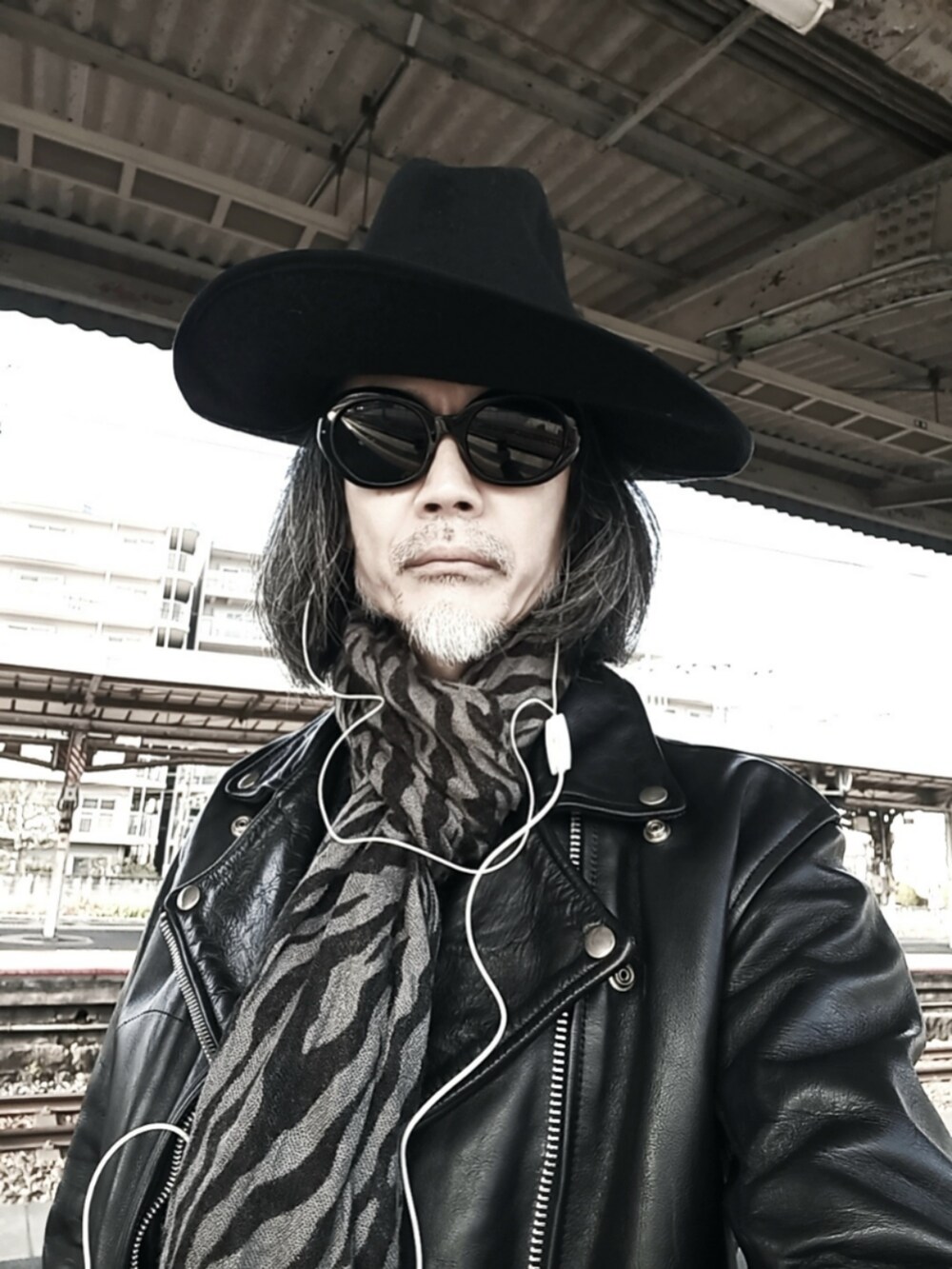 ブラック系のライダースジャケット、ブルー系のデニムパンツ、ブラック系のドレスシューズを着用したメンズの冬コーディネートの4枚目の写真
