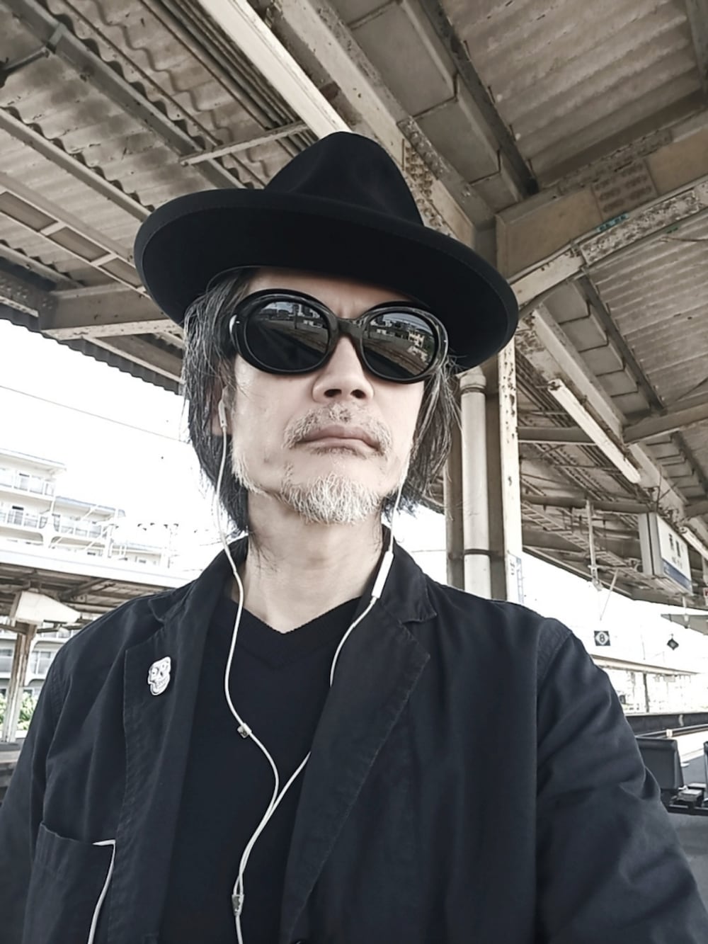 ブルー系のデニムパンツ、ブラック系のドレスシューズ、ブルー系のテーラードジャケットを着用したメンズの春コーディネートの3枚目の写真