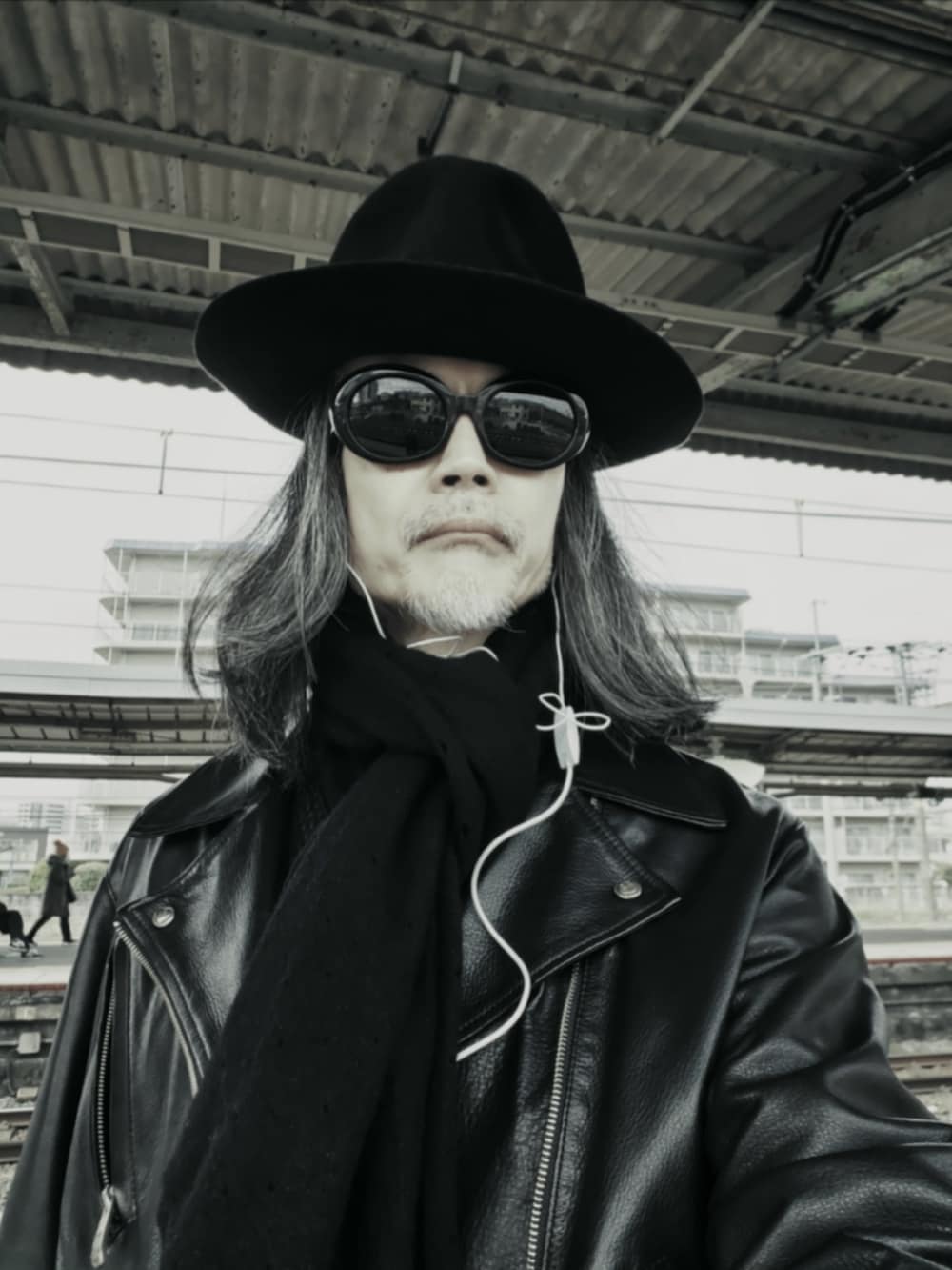 ブラック系のライダースジャケット、ブラック系のデニムパンツ、ブラック系のドレスシューズを着用したメンズの冬コーディネートの4枚目の写真