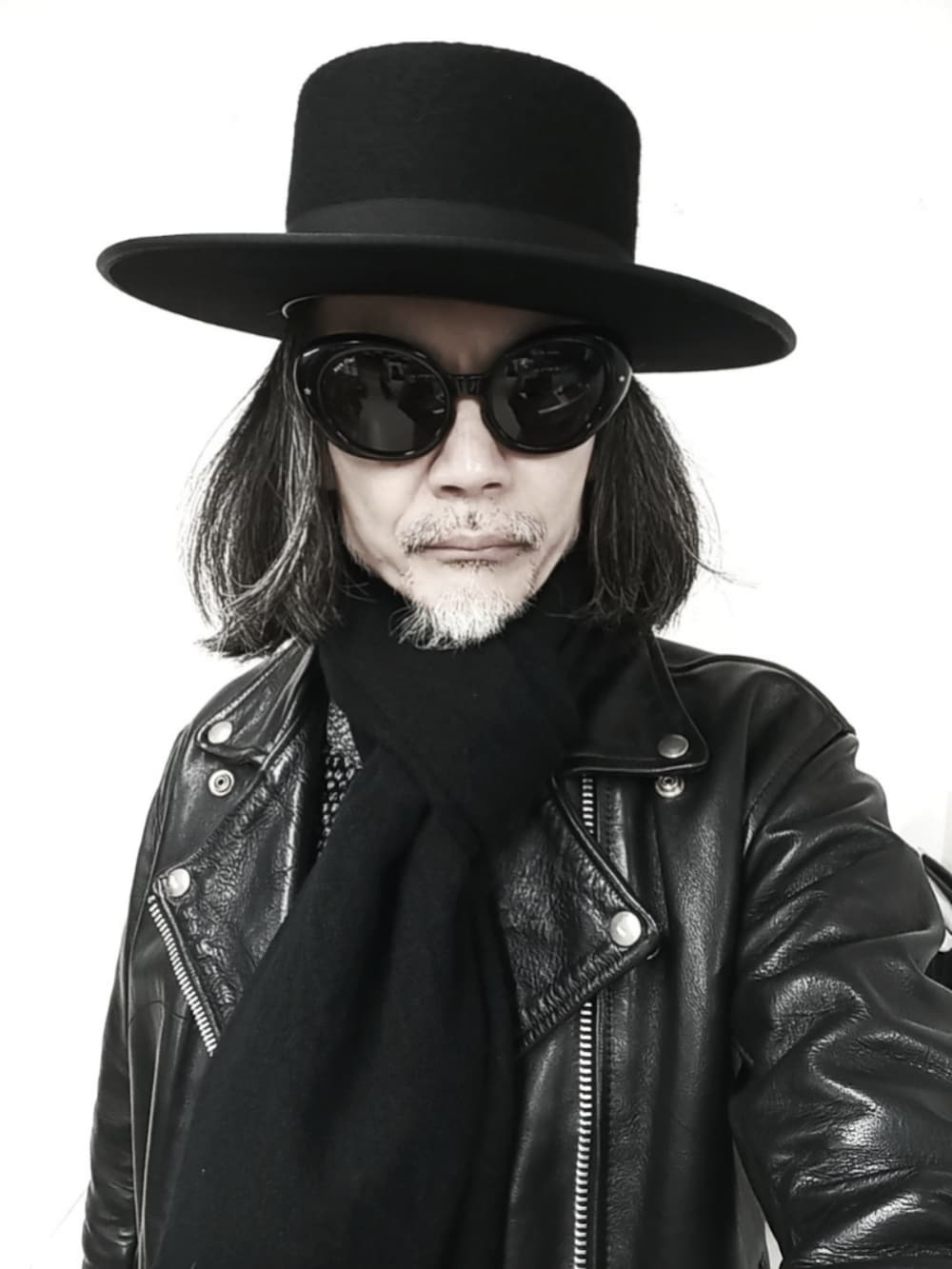 ブラック系のデニムパンツ、ブラック系のドレスシューズ、ブラック系のライダースジャケットを着用したメンズの春コーディネートの3枚目の写真