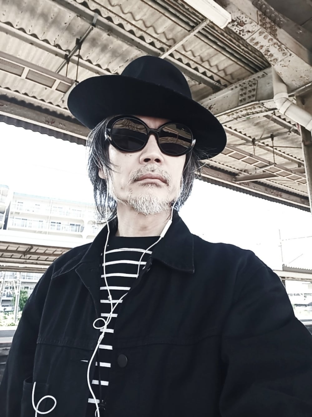 ブラック系のTシャツ/カットソー、ブラック系のカーゴパンツ、ブラック系のドレスシューズを着用したメンズの春コーディネートの4枚目の写真