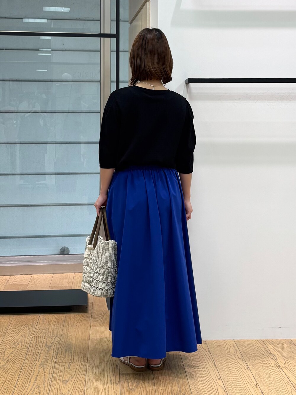 グレー系のカーディガン/ボレロ、ホワイト系のトートバッグ、ブルー系のスカートを着用したレディースの春コーディネートの10枚目の写真