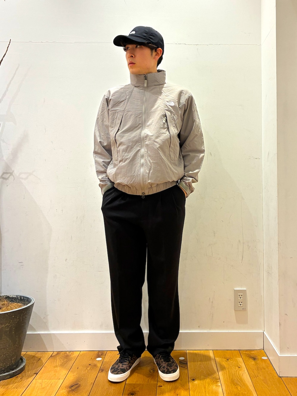 ブラック系のその他パンツ、ブラウン系のスニーカー、グレー系のニット/セーターを着用したメンズの春コーディネートの2枚目の写真