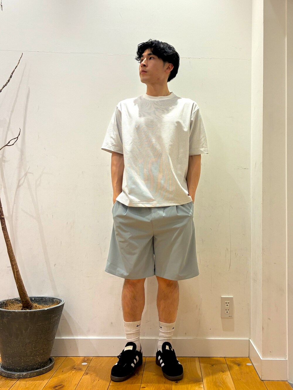 ブラック系のスニーカー、グリーン系のその他パンツ、ホワイト系のTシャツ/カットソーを着用したメンズの春コーディネートの2枚目の写真