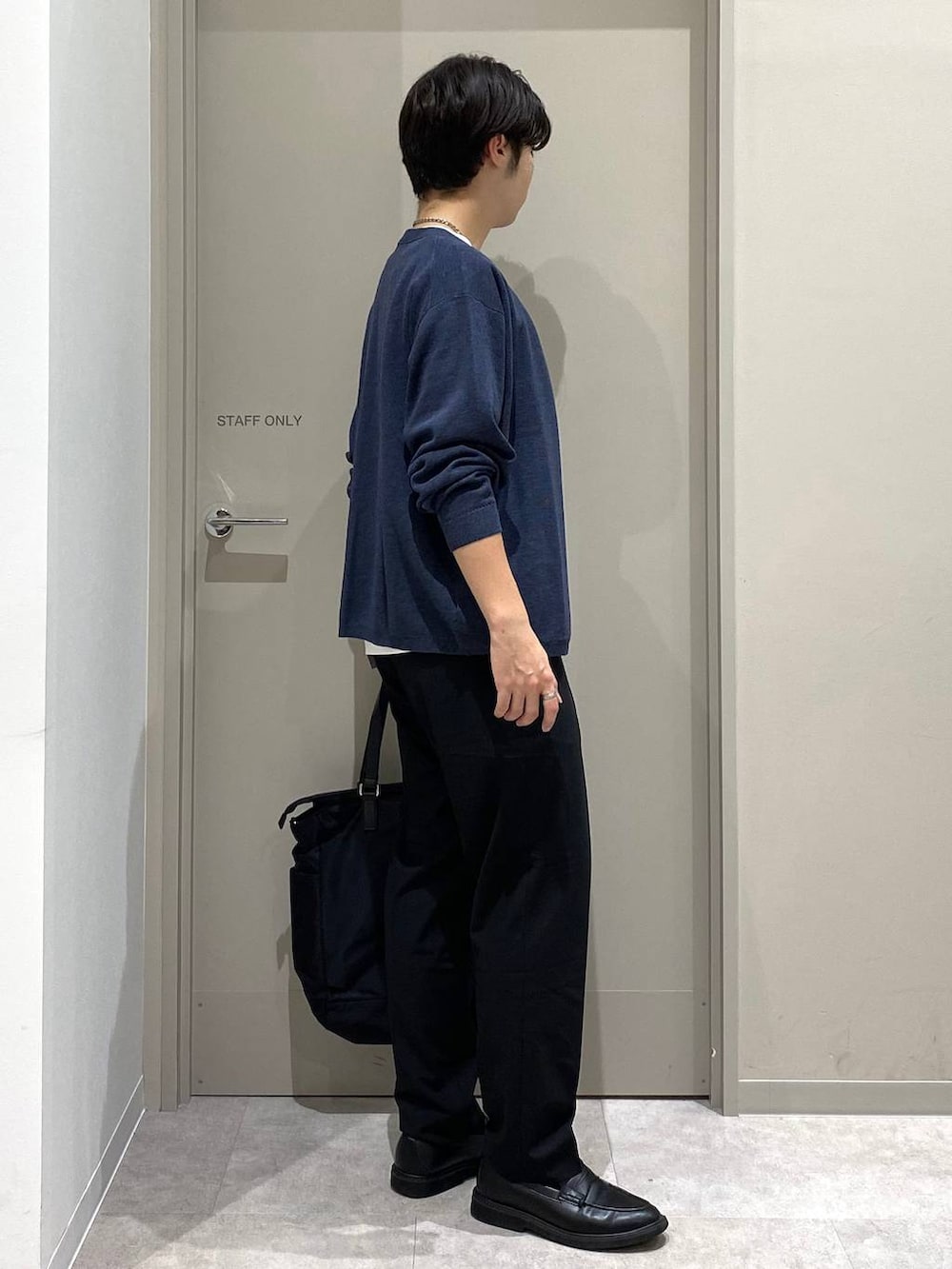 ブラック系のスラックス、ホワイト系のTシャツ/カットソー、グレー系のその他シューズを着用したメンズの秋コーディネートの2枚目の写真