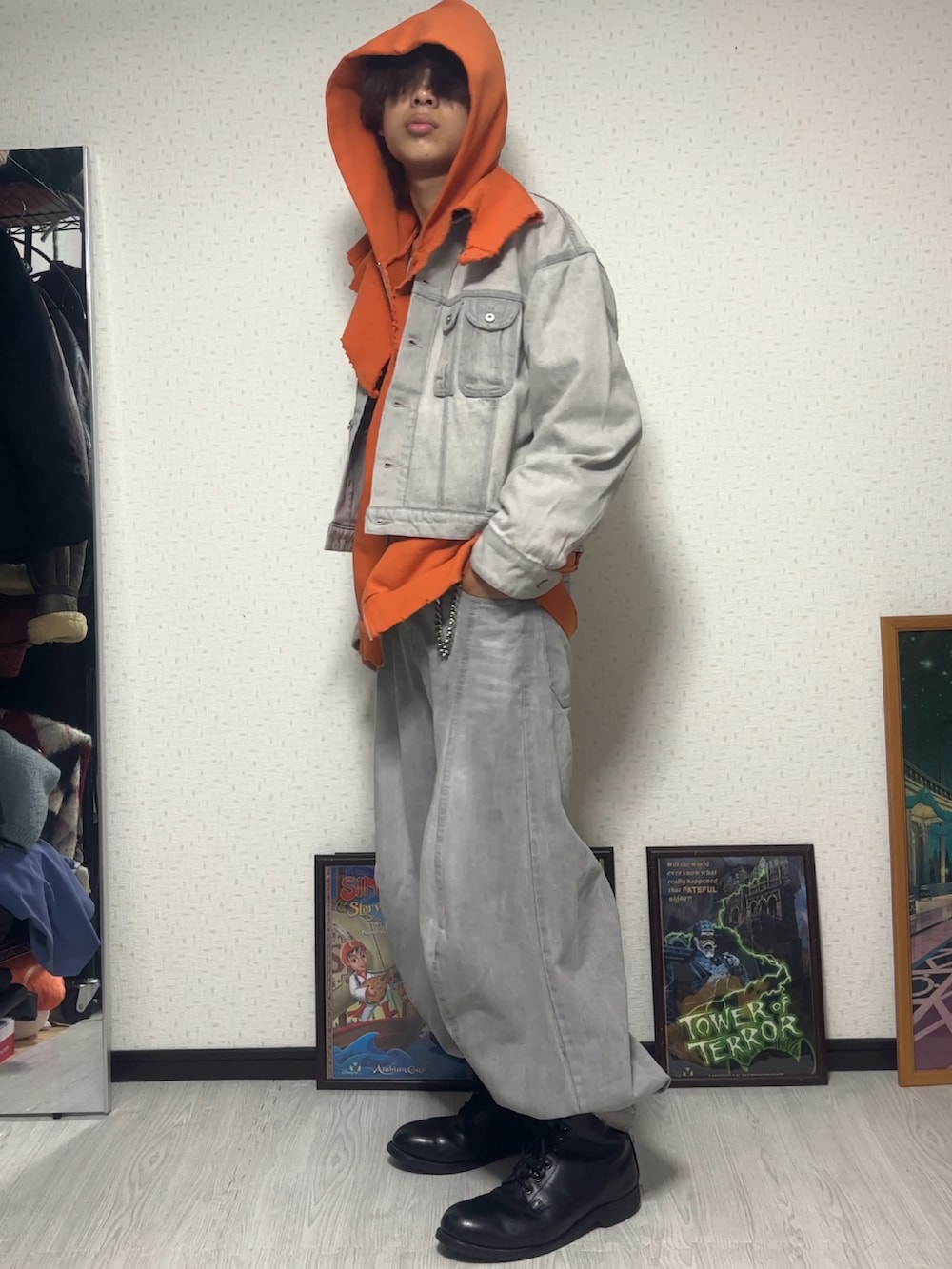 オレンジ系のパーカー、グレー系のデニムジャケット、グレー系のデニムパンツを着用したメンズの秋コーディネートの2枚目の写真