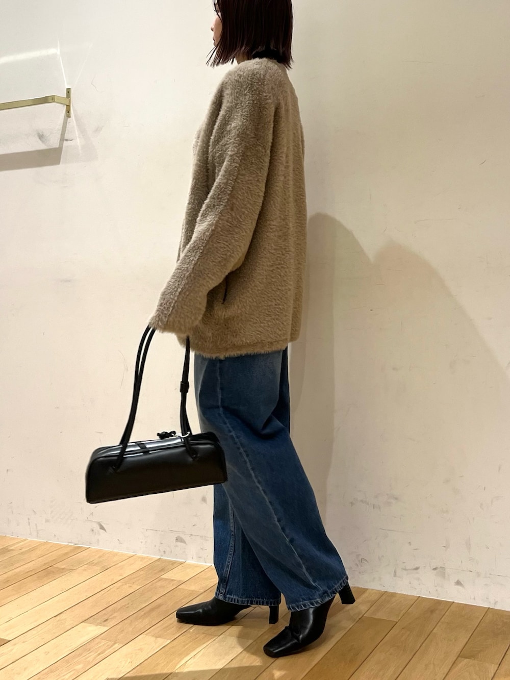 ブラック系のショルダーバッグ、ブラウン系のカーディガン/ボレロ、イエロー系のTシャツ/カットソーを着用したレディースの秋コーディネートの2枚目の写真