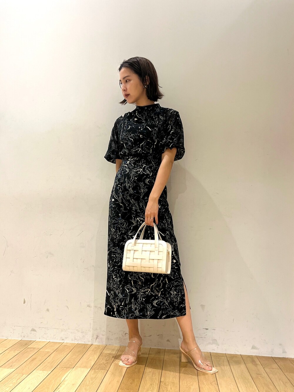 ブラック系のワンピース、その他のサンダル、ホワイト系のショルダーバッグを着用したレディースの夏コーディネートの2枚目の写真