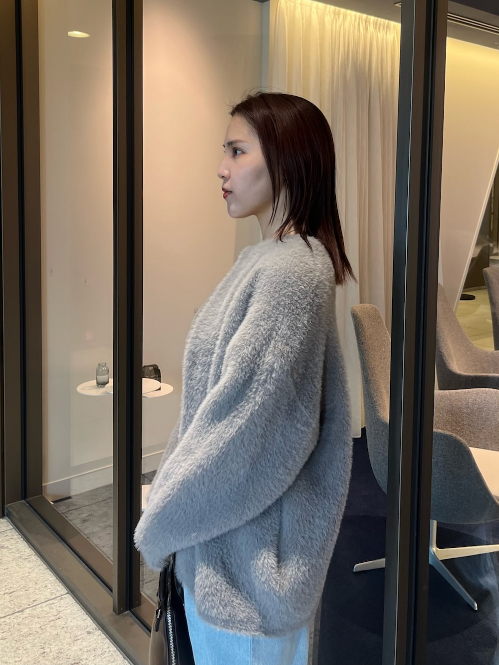 ブルー系のデニムパンツ、ホワイト系のTシャツ/カットソー、ブラウン系のボストンバッグを着用したレディースの夏コーディネートの5枚目の写真