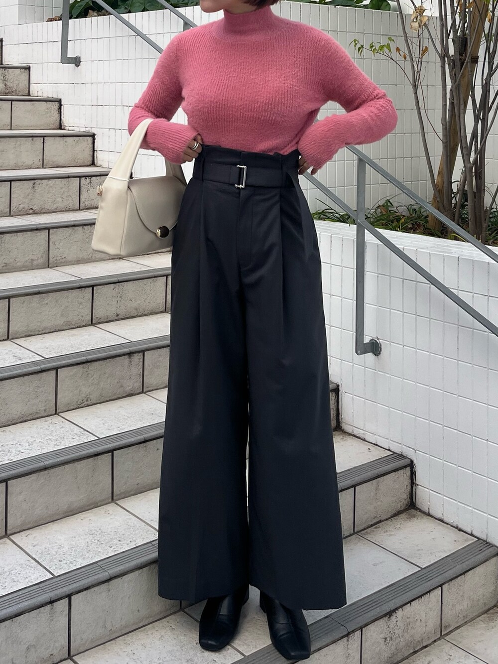 グレー系のその他パンツ、ホワイト系のハンドバッグ、ホワイト系のダウンジャケット/コートを着用したレディースの冬コーディネートの5枚目の写真