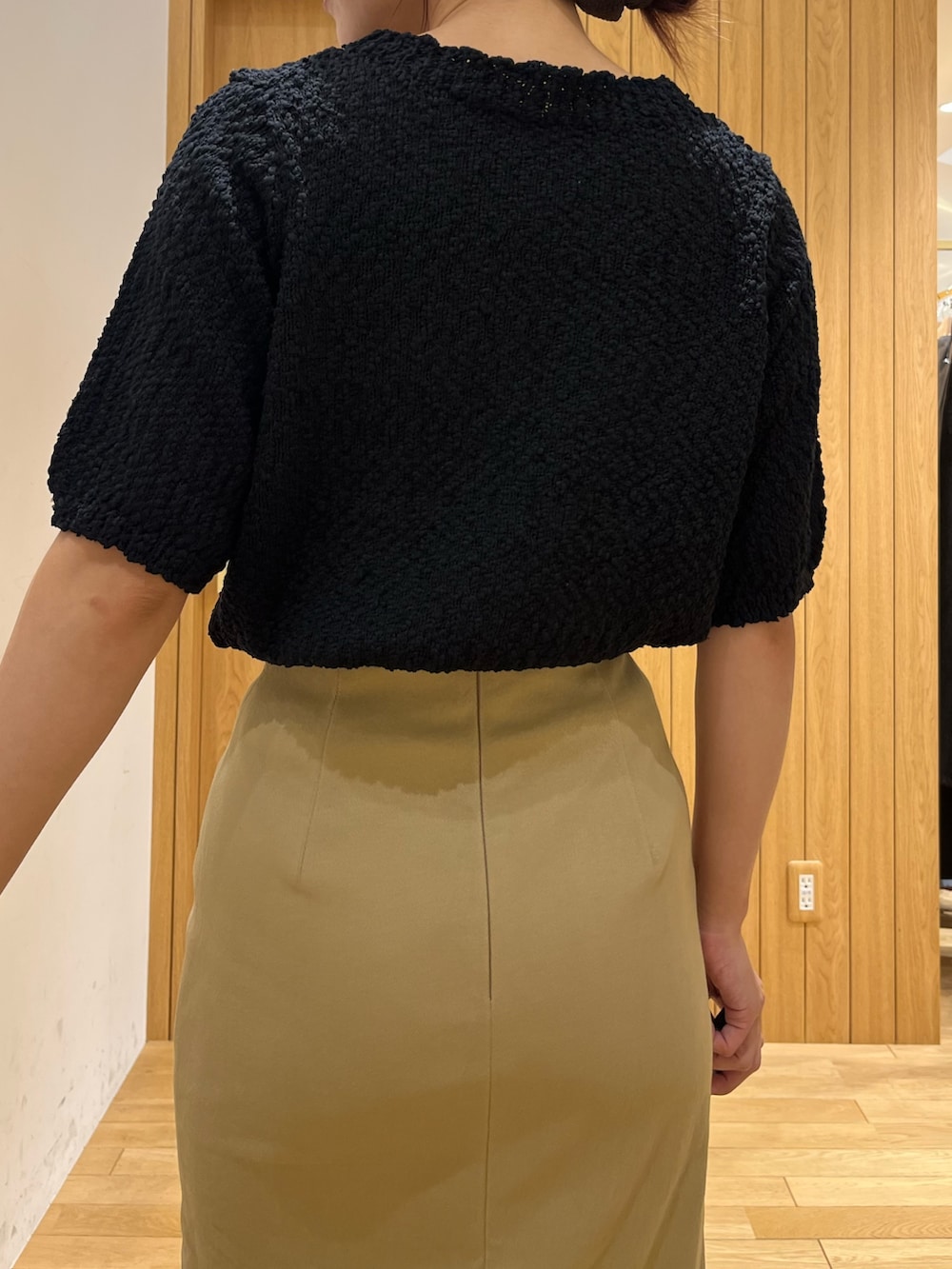 ブラック系のブーツ、ベージュ系のスカート、ブラウン系のボストンバッグを着用したレディースの秋コーディネートの6枚目の写真