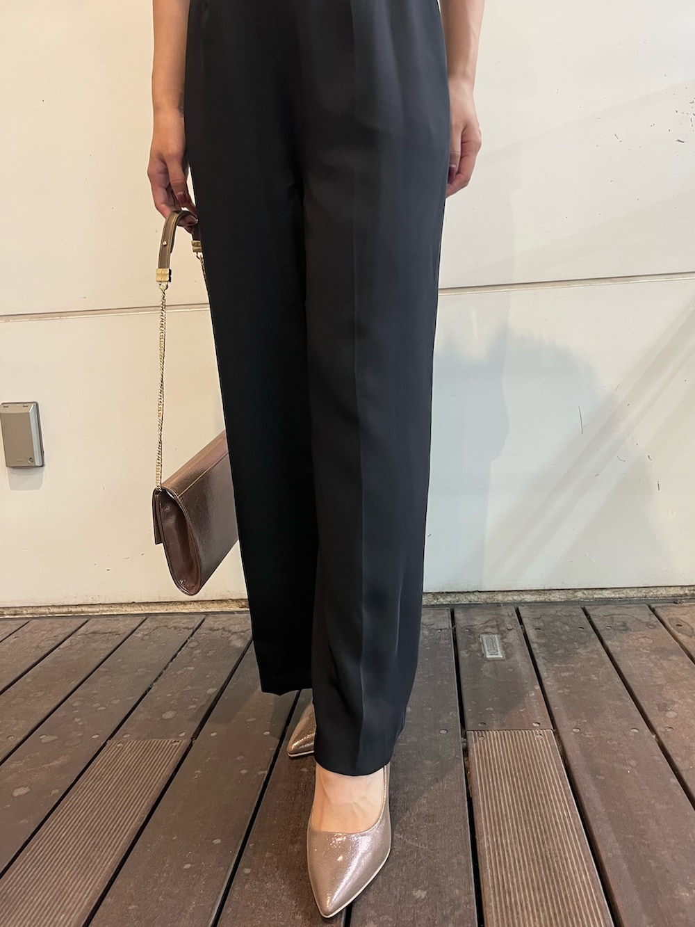 ゴールド系のハンドバッグ、その他のパンツドレス、グレー系のテーラードジャケットを着用したレディースの秋コーディネートの6枚目の写真