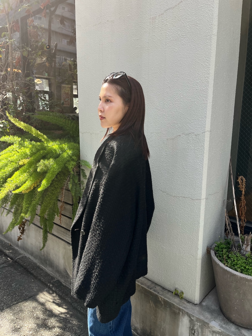 ホワイト系のニット/セーター、ブルー系のデニムパンツ、ブラック系のその他アウターを着用したレディースの冬コーディネートの6枚目の写真