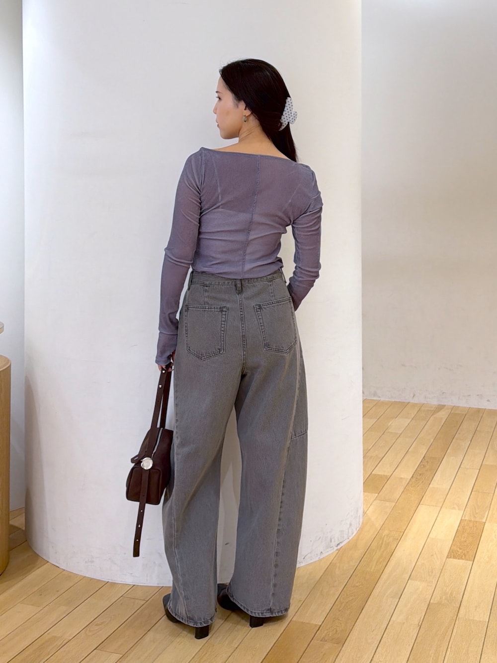 グレー系のデニムパンツ、ブルー系のTシャツ/カットソー、ブラック系のブルゾンを着用したレディースの秋コーディネートの6枚目の写真